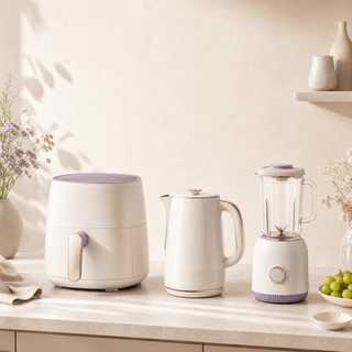 Modern kitchen appliances arranged on a warm neutral background